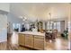 Open concept living space with hardwood floors and kitchen island, filled with natural light at 20040 E Doane Dr, Aurora, CO 80013