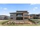 Backyard of a two-story home with a patio, balcony, and manicured landscaping on a sunny day at 10869 Bluffside Dr, Lone Tree, CO 80124