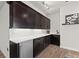 Modern bar area featuring sleek cabinets, a mini fridge, a sink, and counter space at 10869 Bluffside Dr, Lone Tree, CO 80124