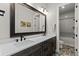 Modern bathroom with double vanity, dark wood cabinets, white counters, and a tiled shower/tub combo at 10869 Bluffside Dr, Lone Tree, CO 80124