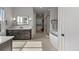 Bright bathroom with a soaking tub, walk-in shower, double vanity and herringbone tile floors at 10869 Bluffside Dr, Lone Tree, CO 80124