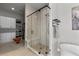 Bright bathroom with a walk-in shower, soaking tub, custom closet and herringbone tile floors at 10869 Bluffside Dr, Lone Tree, CO 80124