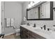Modern bathroom featuring a double vanity, neutral color palette, and matte black hardware and fixtures at 10869 Bluffside Dr, Lone Tree, CO 80124