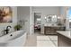 Bright bathroom with a freestanding tub, tiled floors, modern vanity, and view to the bedroom at 10869 Bluffside Dr, Lone Tree, CO 80124