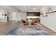 Open dining area with modern light fixtures, bar area, modern cabinets, and natural light at 10869 Bluffside Dr, Lone Tree, CO 80124
