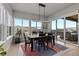 Well-lit dining room with a modern chandelier and large windows and sliding glass doors at 10869 Bluffside Dr, Lone Tree, CO 80124