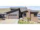 Lovely home exterior with stone accents, a two-car garage, and a charming front yard at 10869 Bluffside Dr, Lone Tree, CO 80124