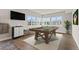 Entertainment room featuring a pool table, large windows, and modern decor at 10869 Bluffside Dr, Lone Tree, CO 80124