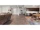 Open-concept basement living area featuring wood floors, a wet bar, and a comfortable seating arrangement at 10869 Bluffside Dr, Lone Tree, CO 80124