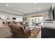 Spacious living room with light flooring, large windows, sliding doors to outside, and comfortable seating at 10869 Bluffside Dr, Lone Tree, CO 80124