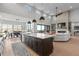 Bright, open living space with a kitchen, dining area, and living room with a fireplace at 10869 Bluffside Dr, Lone Tree, CO 80124