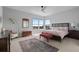 Bright main bedroom with a ceiling fan, large windows, and a comfortable seating area at 10869 Bluffside Dr, Lone Tree, CO 80124