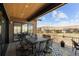 This covered patio features a dining table and overlooks beautiful neighborhood views at 10869 Bluffside Dr, Lone Tree, CO 80124