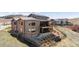 Gorgeous back exterior with a balcony, patio, and beautifully landscaped backyard at 10869 Bluffside Dr, Lone Tree, CO 80124