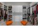 Spacious walk-in closet with custom shelving, drawers, and ample storage for clothes and accessories at 10869 Bluffside Dr, Lone Tree, CO 80124