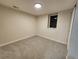 Bright finished basement bedroom with neutral carpeting and window at 8318 Benton Way, Arvada, CO 80003