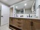 Bathroom boasts double vanity with light oak cabinets at 8318 Benton Way, Arvada, CO 80003