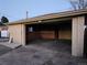 Unfinished attached garage with open door and concrete floor at 8318 Benton Way, Arvada, CO 80003