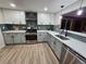 Modern kitchen with stainless steel appliances and herringbone backsplash at 8318 Benton Way, Arvada, CO 80003