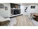 Living room features a stone fireplace and wood-look flooring at 8318 Benton Way, Arvada, CO 80003