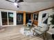 Sunroom with wood walls, flooring, and access to a deck at 8318 Benton Way, Arvada, CO 80003