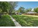 Expansive backyard with lush lawn, mature trees, and a view of the neighborhood at 1975 Cody St, Lakewood, CO 80215