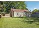 Backyard of home featuring a well-kept lawn, mature trees, and a storage shed at 1975 Cody St, Lakewood, CO 80215