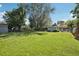 Large backyard with healthy lawn, mature trees, and detached garage or shed at 1975 Cody St, Lakewood, CO 80215