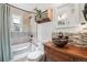 Bathroom showcasing a unique vessel sink, stylish vanity, and tiled shower-tub combo at 1975 Cody St, Lakewood, CO 80215