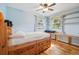 Bright bedroom with hardwood floors, natural light, built-in shelves and a ceiling fan at 1975 Cody St, Lakewood, CO 80215
