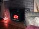 Brick fireplace and brick floor with a black wood burning stove insert for a cozy living space at 1975 Cody St, Lakewood, CO 80215