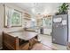 Cozy kitchen with light cabinets, dining table and stainless refrigerator at 1975 Cody St, Lakewood, CO 80215