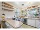 Bright kitchen featuring modern appliances, open shelving and butcher block countertops at 1975 Cody St, Lakewood, CO 80215