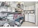 Pantry combined with laundry room featuring white shelving units and appliances at 1975 Cody St, Lakewood, CO 80215