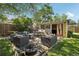 Outdoor patio area with comfortable seating, a fire pit, and a dining table for entertaining guests at 1975 Cody St, Lakewood, CO 80215