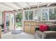 Bright sun room with a door to the yard featuring comfortable seating and natural light at 1975 Cody St, Lakewood, CO 80215
