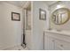 Bathroom with a vanity, a round mirror and a concealed washer and dryer at 701 Harlan St # E72, Lakewood, CO 80214