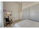 Bedroom with grey wood floors, a desk and closet, and access to a hallway and bathroom at 701 Harlan St # E72, Lakewood, CO 80214
