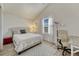 Cozy bedroom features a large window, neutral tones and vaulted ceilings at 701 Harlan St # E72, Lakewood, CO 80214