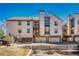 View of a multi-level condo with private balcony and attached garage, great for convenient parking at 701 Harlan St # E72, Lakewood, CO 80214
