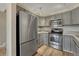 Cozy kitchen with stainless steel appliances, granite countertops, and grey wood cabinetry at 701 Harlan St # E72, Lakewood, CO 80214