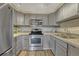 Well-equipped kitchen features stainless steel appliances, sleek gray cabinetry, and ample counter space at 701 Harlan St # E72, Lakewood, CO 80214