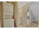 Convenient laundry area with stackable washer and dryer, storage cabinet, and easy access at 701 Harlan St # E72, Lakewood, CO 80214