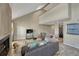 Spacious living room with vaulted ceilings, fireplace, skylight, wood flooring, and abundant natural light at 701 Harlan St # E72, Lakewood, CO 80214