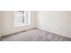 Bright bedroom with grey carpet and a window at 1547 Orchard St, Brighton, CO 80601