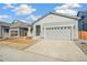 Gray exterior of a charming ranch home with attached garage and front porch at 1547 Orchard St, Brighton, CO 80601