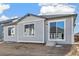 Rear view of the house showcasing gray siding at 1547 Orchard St, Brighton, CO 80601