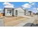 New construction home with gray siding, landscaping, and a two-car garage at 1547 Orchard St, Brighton, CO 80601