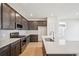 Modern kitchen with dark cabinets, quartz countertops and stainless steel appliances at 1547 Orchard St, Brighton, CO 80601