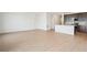 Spacious living room with light wood-look flooring and kitchen island at 1547 Orchard St, Brighton, CO 80601